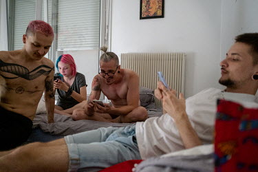 Sergi (centre right) and Igor (right) with friends in their apartment.Faced with increasing levels of abuse in their hometown of Odessa along Ukraine's southern Black Sea coastline, Igor and his boyfr...