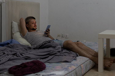 Sergi checks his mobile phone.Faced with increasing levels of abuse in their hometown of Odessa along Ukraine's southern Black Sea coastline, Igor and his boyfriend Sergi decided it was time to leave...