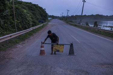 Indigenous people errect a roadblock to close the BR-174 highway at night at the entrance to the Waimiri-Atroari Indigenous Land. Emergency vehicles, trucks with perishable goods and passenger buses a...