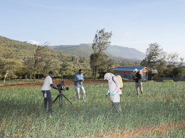 The crew shoot a farmer spraying crops while dressed in full protective clothing during the filming of an episode of the TV program Shamba Shape Up, produced by The Mediae Company.Launched in 2012 by...