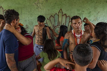 Young people paint themselves for a celebration party at the launching of the consultation protocol of the Arara indigenous people, in Iriri village, in the Cachoeira Seca Indigenous Land. With the pr...