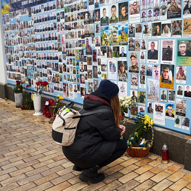 A woman adds a photo of her husband, Andriy Shiyan 'Gora', to the Memory Wall of Fallen Defenders of Ukraine in Russian-Ukrainian war. Andriy (26) was killed defending his country on 11 December 2022.