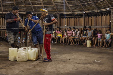 Indigenous people, in Laranjal Village on Arara Indigenous Territory, drink 'caxiri', a traditional drink made from manioc, and play traditional instruments during a cerimony to celebrate the delivery...