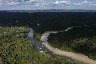 An aerial view of the confluence of the river Pixaxa and waters polluted by mining of the river Curua. The Curua River acts as a boundary between the territory of Bau village, which lives off forest p...