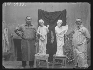 These are probably sculptors from the Fondation de l'Oeuvre Notre-Dame posing with two statues of musicians in the large gable of the central portal. Photo taken between 1890 and 1920.~~( Archive Pict...