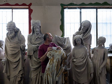 Albert Martz, head of the sculpture workshop at the Fondation de l'Oeuvre Notre-Dame, in the storage warehouse with plaster casts of statues made from the originals in Strasbourg Cathedral.