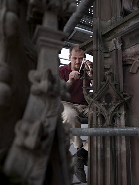 Nicolas Eberhardt, a fitter for the Fondation de l'Oeuvre Notre-Dame, takes measurements from the Saint-Laurent portal in Strasbourg Cathedral. From these measurements he draw plans that will be used...