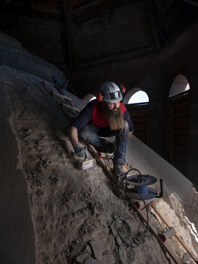 Adrien Schaaff, chief mason specialising in the renovation of historical monuments for the company Chanzy Pardoux on the extrados of the dome at the crossing of the transept during its restoration. He...