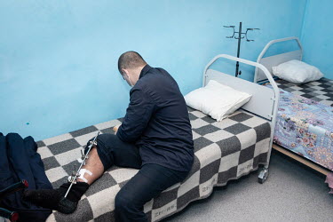 A Russian prisoner of war, with an injured leg, is treated in the hospital in a prison camp.