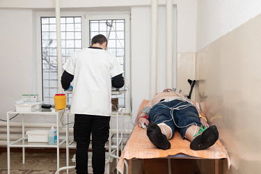 A Russian prisoner of war is examined by medical staff in a prison camp's clinic.