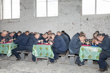 Russian prisoners of war eating one of the three meals they get daily. The prisoners are responsible for cooking their own food using supplies from the prison.