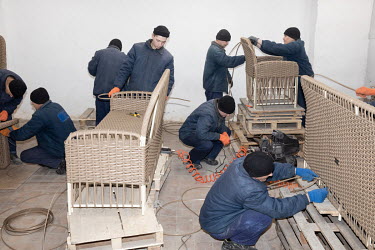 Russian prisoners of war making furniture in a camp workshop.