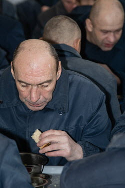 Russian prisoners of war eating one of the three meals they get daily. The prisoners are responsible for cooking their own food using supplies from the prison.