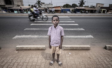 Eight-year-old Romeo Kudadjey was hit on this road crossing while walking home. The speeding motorcycle's impact snapped Romeo's tibia bone in two, leaving him with a permanent scar. He was unable to...