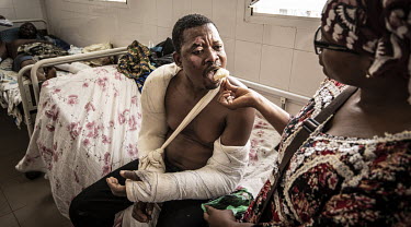 A man with broken arms following a motorcycle accident is fed at the Sylvanus Olympio hospital.As motorcycle ownership in sub-Saharan Africa has grown from less than five million in 2010 to an estimat...