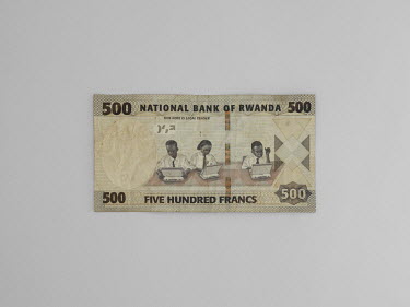 A 500 Franc note depicting school children working on computer laptops. Stitched photograph