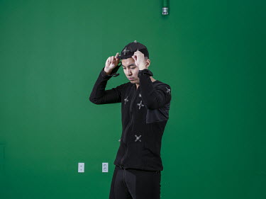 A person wearing sensors in a motion capture green screen studio at the headquarters of Nexon, a Japanese video game publisher of online games for PC and mobile. Stitched photograph