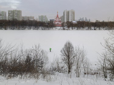 A Delivery Club courier walks in the snow during the cours of his work. Delivery Club is Russia's largest food and grocery delivery service, active in 350 of the country's cities. Stitched photograph