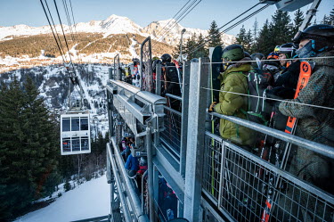 Winter sports enthusiasts waiting for the gondola from the La Plagne resort to the other side of the Vallandry/Les Arc valley. ~~To attract more tourists, ski resorts are expanding their offerings bey...