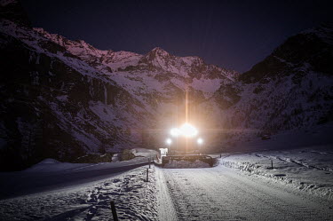 A snow plough smooths the surface of a run at night after the skiing has stopped.The control room staff iare supplemented by six full-time employees and one intern, and during the winter months, the s...