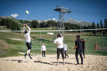 Orthodox Jewish tourists playing volleyball during their annual summer visit to the resort.The Alps have long been known for their winter tourism, but in recent years, there has been a push to attract...