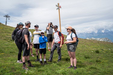 Hikers on a hillside in the summer season.The Alps have long been known for their winter tourism, but in recent years, there has been a push to attract tourists in the summer as well. This has been dr...