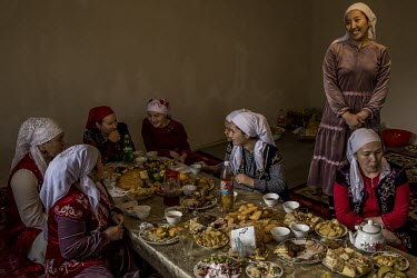 In the village of Beinetkech, at the end of the very long 'dastarkhan' (low dining table) laden with food for Naouriz, the spring festival, the women of the family joke and chat.