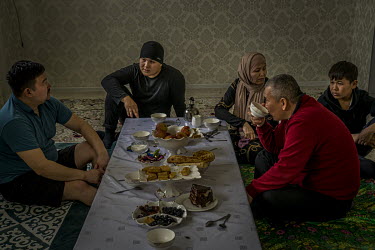 In his living room in a suburb of Zhanaozen, Muratbai Zhumagaliev (red jumper), the local leader of the opposition Democratic Party of Kazakhstan, shares tea with the leader of the DPZ in Karanganda,...