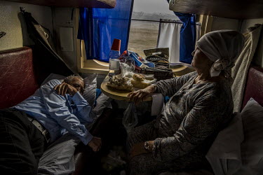 A Kazakh couple on their way to Kyzylorda from Almaty (a 23-hour journey) in their compartment. The train remains the mode of transport for the classes less favoured by the economic boom in Kazakhstan...
