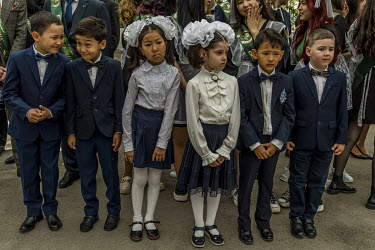 Schoolchildren stand at attention during the end of the school year ceremony.