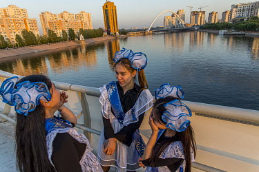 School girls chat on the Atyrau Bridge, named after a gift from the Atyrau oil region to the capital on the occasion of its 20th anniversary. It is ^Posledni Zvonok^ (last school bell), the last day b...