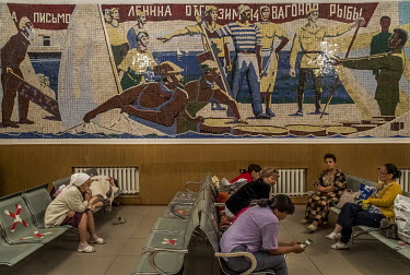 In the waiting hall of Aralsk railway station, a large mosaic wall commemorates a glorious episode from the history of the Aral Sea fishermen when a contribution from the town provided 14 wagons of fi...