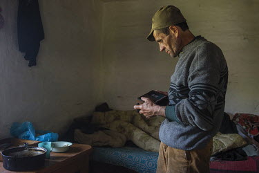 Longa Feodor is listening to his radio.High in the mountains above Poienile de sub Munte, said to be Romania's largest village, is an unnamed community of smallholders that some callDardila's Hill, af...