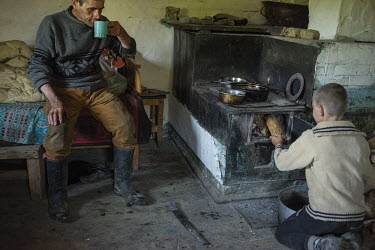 Longa Fedor, one of the permanent residents of the mountain village, with one of his sons. High in the mountains above Poienile de sub Munte, said to be Romania's largest village, is an unnamed commun...