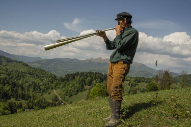 Longa Fedor, one of the permanent residents who lives in the mountain village, playing a homemade instrument. He says he is lonely for most of the time and music is a way to kill time. High in the mou...