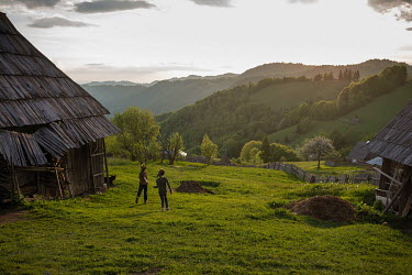 Two girls playing outside their houses.High in the mountains above Poienile de sub Munte, said to be Romania's largest village, is an unnamed community of smallholders that some callDardila's Hill, af...