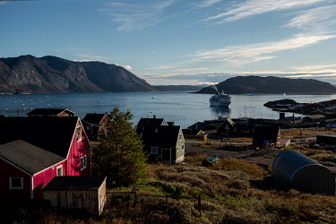 A cruise liner approaches the bay, an increasingly common sight as tourism is encouraged by the Greenlandic government. Mass tourism, mainly via cruise ship, is increasing in Greenland, as ice melts a...