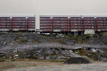 A state residential housing complex with a board walk below it running along the coastline around the old city.