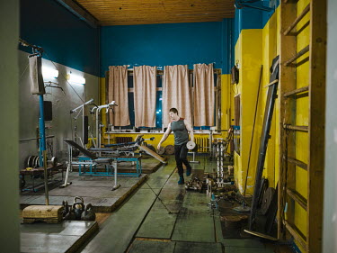 A coal miner uses weights in the mine's gym.