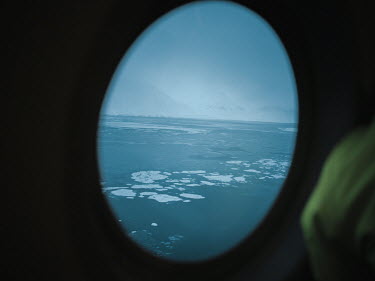 A view of the sea and sea ice from an aircraft. Ice in the Arctic Ocean is shrinking rapidly. Rising temperatures are causing it to melt faster and faster, creating new sea lanes. Over the last decade...