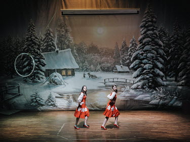 Two young women on stage in the cultural centre where regular performances are held, especially on holidays.
