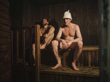 After a strenuous shift, two coal miners relax in a sauna.