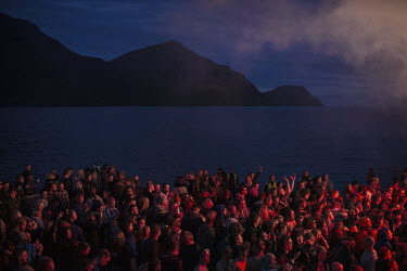 People gathered for an outdoor concert at the water's edge during G! Festival, a music festival that takes place every summer.