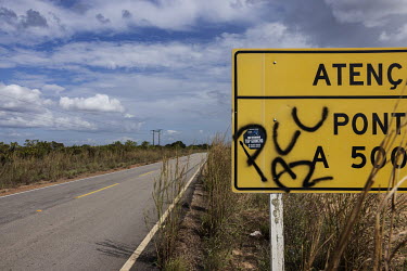A road sign defaced by a criminal organisation's graffiti on highway RR-205 on the route connecting Boa Vista to the clandestine ports on the Uraricoera River used by illegal miners to enter the Yanom...