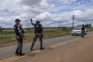 Military police officers search a car carrying miners coming from Yanomami Indigenous Land on highway RR-205 near a side road that leads to clandestine ports on the Uraricoera River, one of the main a...