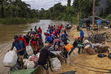Miners ( garimpeiros ) disembark a boat at a clandestine port on the banks of the Uraricoera River after fleeing the Yanomami Indigenous Land following a crackdown by the new government. Since the beg...
