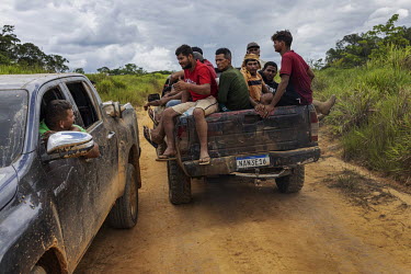 Illegal miners ( garimpeiros ) who left the Yanomami Indigenous Land ride in a pickup truck along the road that connects a clandestine port on the banks of the Uraricoera River to the village of Reisl...