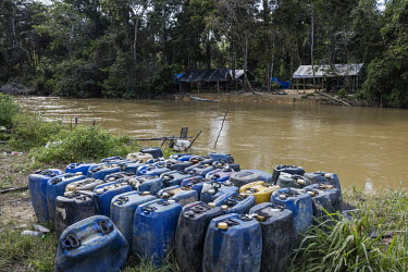 Jerry cans containing gallons of fuel wait to be transported by boat to an illegal mining site in the Yanomami Indigenous Land in a clandestine port on the banks of the Uraricoera River, near the vill...