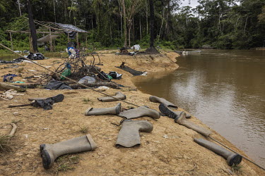 Rubber boots used by illegal miners ( garimpeiros ) in the Yanomami Indigenous Land and abandoned by them as they fled from a clandestine port on the banks of the Uraricoera River following a crackdow...