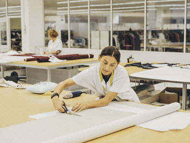 A pattern cutter at work in the clothing company Inditex's womens wear department.